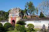The Hung Mieu (Hưng Miếu) temple was built in the 19th century and dedicated to the veneration of Emperor Gia Long's mother and father.<br/><br/>Emperor Gia Long ordered the construction of Hue Citadel in 1805. The vast complex is built according to the notions of fengshui or Chinese geomancy, but following the military principles of the noted 18th century French military architect Sebastien de Vauban. The result is an unusual and elegant hybrid, a Chinese-style Imperial City carefully aligned with surrounding hills, islands and waterways, but defended by massive brick walls between 6-12 metres high and 2.5 metres thick, punctuated by towers, ramparts, a massive earth glacis, and 24 Vauban-inspired bastions.<br/><br/>The entire complex was further protected by wide moats, crossed by gracefully arched stone bridges leading to ten gates, the chief of which is Cua Ngo Mon, the south-east facing ‘Meridian Gate’. To compound the exotic hybrid effect, guard posts designed as Chinese-style miradors, complete with sweeping eaves crowned by imperial dragons, surmounted each gate. Finally, directly in front of the Ngo Mon Gate, a massive brick fort 18 metres high was constructed both as an additional barrier against malign spirits, and as a defensive redoubt.<br/><br/>The area within the Citadel - in all, 520 hectares (1300 acres) - comprises three concentric enclosures, the Civic, Imperial and Forbidden Purple Cities. Access is by way of ten fortified gates, each of which is reached by a low, arched stone bridge across the moat. In imperial times a cannon would sound at 5am and 9pm to mark the opening and closing of the gates.<br/><br/>Hue was the imperial capital of the Nguyen Dynasty between 1802 and 1945. The tombs of several emperors lie in and around the city and along the Perfume River. Hue is a UNESCO World Heritage Site.
