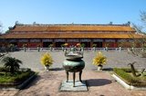 The Thế Miếu, also called Thế Tổ Miếu, is an ancestral temple and was constructed on the orders of Emperor Minh Mạng in 1822-1823. It honours the emperors of the Nguyễn Dynasty. Nine dynastic urns (Vietnamese cửu đỉnh 九鼎) in front of the Thế Miếu were also cast in 1822 and dedicated to the first nine Nguyen emperors.<br/><br/>Emperor Gia Long ordered the construction of Hue Citadel in 1805. The vast complex is built according to the notions of fengshui or Chinese geomancy, but following the military principles of the noted 18th century French military architect Sebastien de Vauban. The result is an unusual and elegant hybrid, a Chinese-style Imperial City carefully aligned with surrounding hills, islands and waterways, but defended by massive brick walls between 6-12 metres high and 2.5 metres thick, punctuated by towers, ramparts, a massive earth glacis, and 24 Vauban-inspired bastions.<br/><br/>The entire complex was further protected by wide moats, crossed by gracefully arched stone bridges leading to ten gates, the chief of which is Cua Ngo Mon, the south-east facing ‘Meridian Gate’. To compound the exotic hybrid effect, guard posts designed as Chinese-style miradors, complete with sweeping eaves crowned by imperial dragons, surmounted each gate. Finally, directly in front of the Ngo Mon Gate, a massive brick fort 18 metres high was constructed both as an additional barrier against malign spirits, and as a defensive redoubt.<br/><br/>The area within the Citadel - in all, 520 hectares (1300 acres) - comprises three concentric enclosures, the Civic, Imperial and Forbidden Purple Cities. Access is by way of ten fortified gates, each of which is reached by a low, arched stone bridge across the moat. In imperial times a cannon would sound at 5am and 9pm to mark the opening and closing of the gates.<br/><br/>Hue was the imperial capital of the Nguyen Dynasty between 1802 and 1945. The tombs of several emperors lie in and around the city and along the Perfume River. Hue is a UNESCO World Heritage Site.